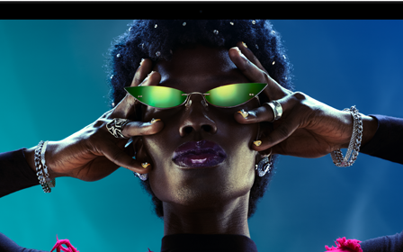 Colourful screen on a MacBook Pro of a person crowdsurfing at a party, showcasing the vibrant Liquid Retina XDR display